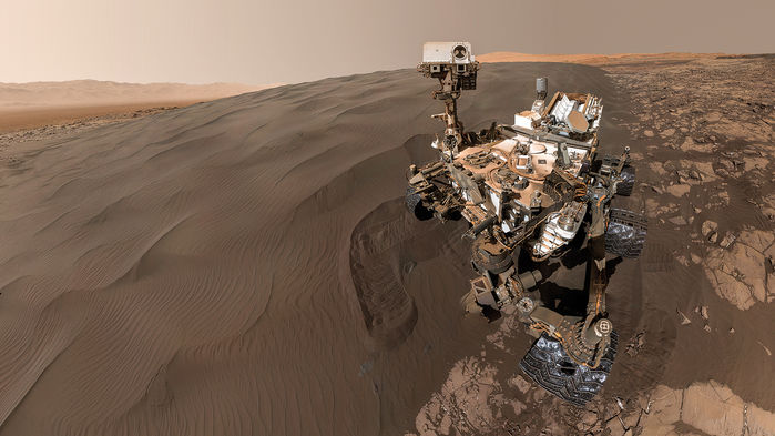 Curiosity rover on sandy hillside