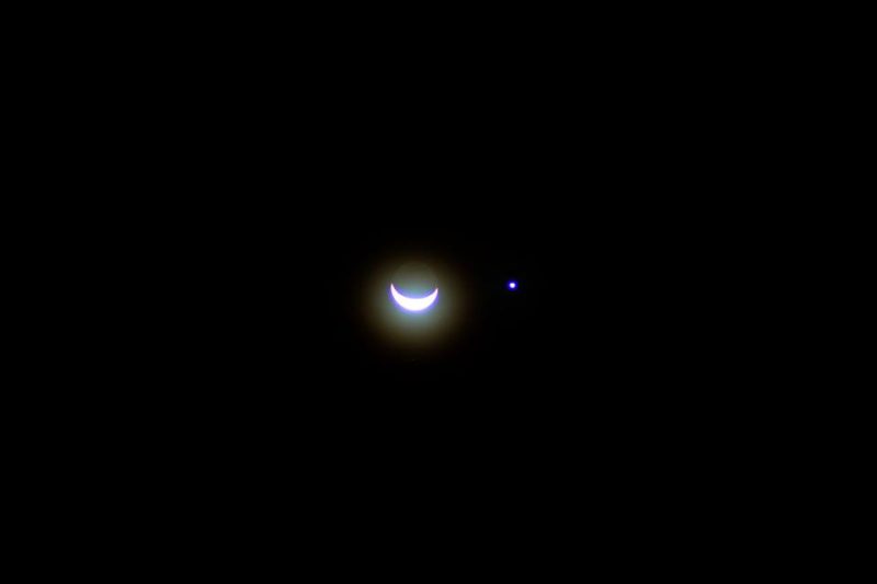 Photo by Vermont Coronel of the moon and a cool-hued Venus, an hour in a dark sky before sunrise in Manila.