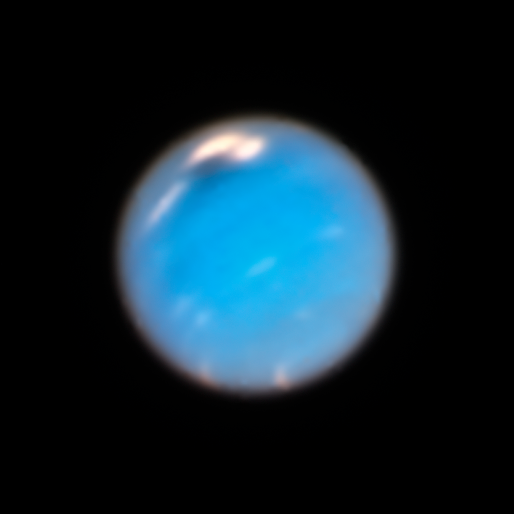 Blue planet with small, dark oval with white ovals next to it.