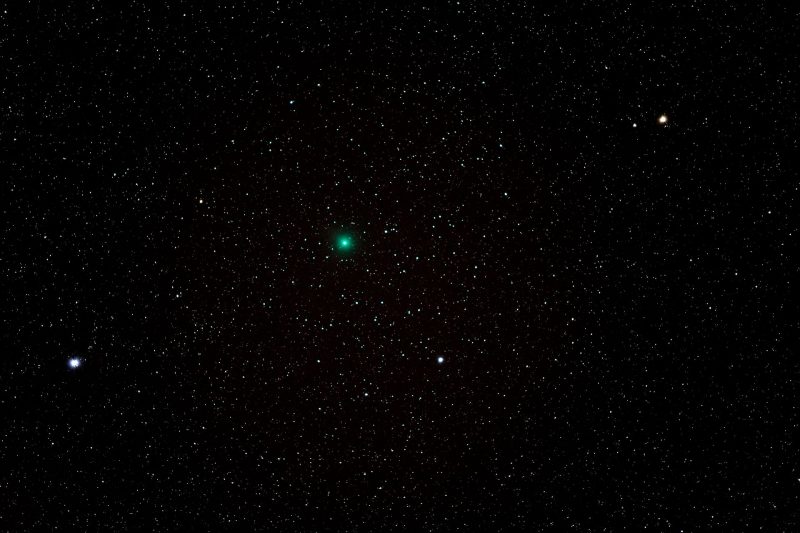 A greenish fuzzy comet against a star field.