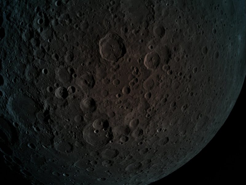 Dark gray lightly cratered moon surface.