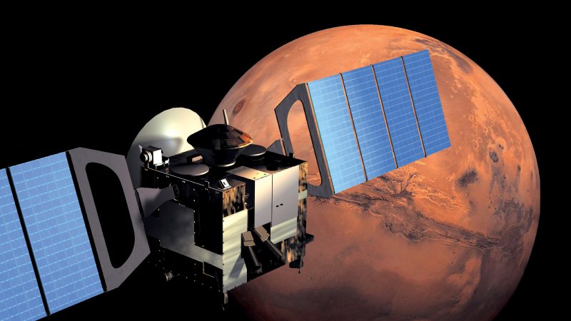 Spacecraft with wide solar panels and large antenna orbiting Mars.