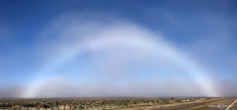 Bright foggy arc against low-lying fog on the desert.