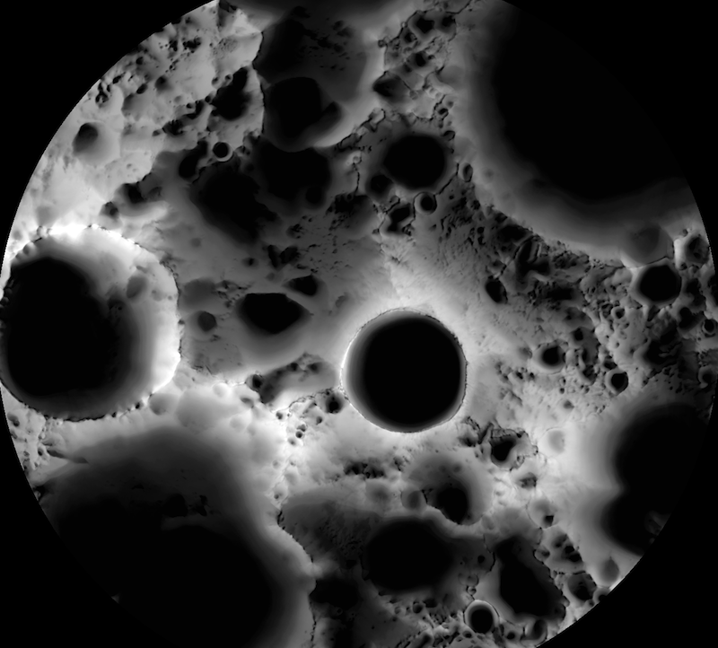 Skull-like image of region of lunar south pole showing craters as solid black circles.