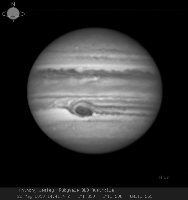 Jupiter in black and white with large black spot below the equator.