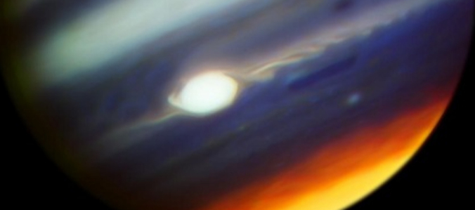 Bands in colors on Jupiter with large oval white spot.