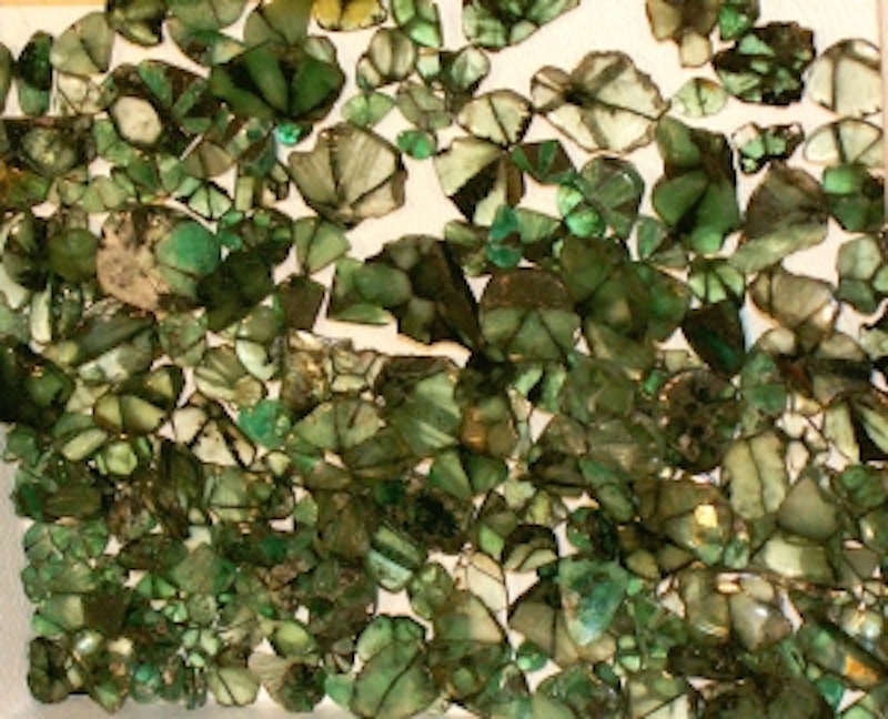 Patchy field of crystals of varying green colors.