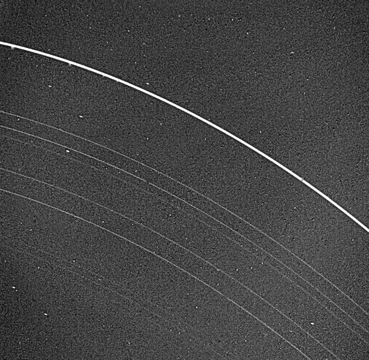 Bright, thin rings partial view with stars in background.