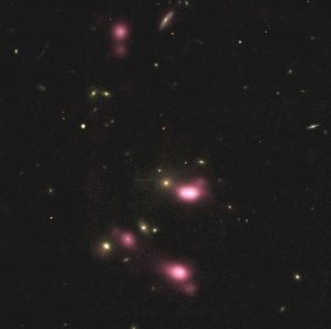 Scattered oblong pink blobs, lighter toward the center, with smaller scattered yellow dots.