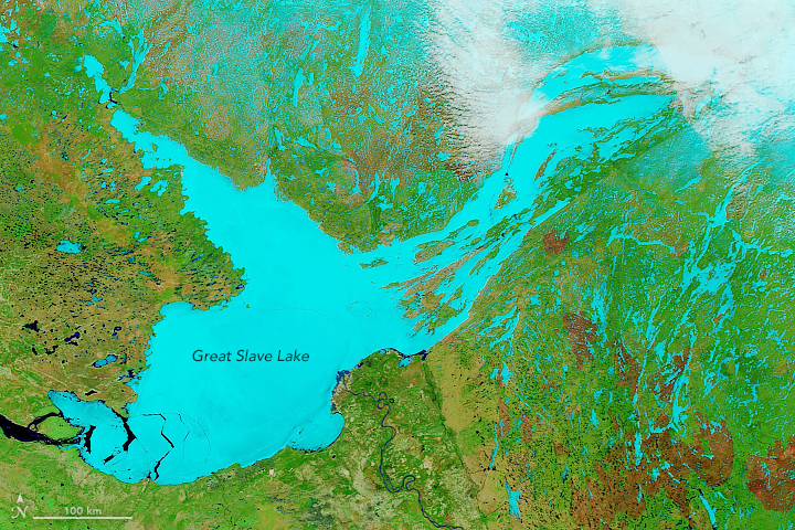 Same image as above, but the lake is aqua against a green background.