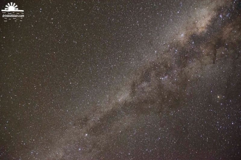 Dense star field with Milky Way with dark rifts clearly visible.