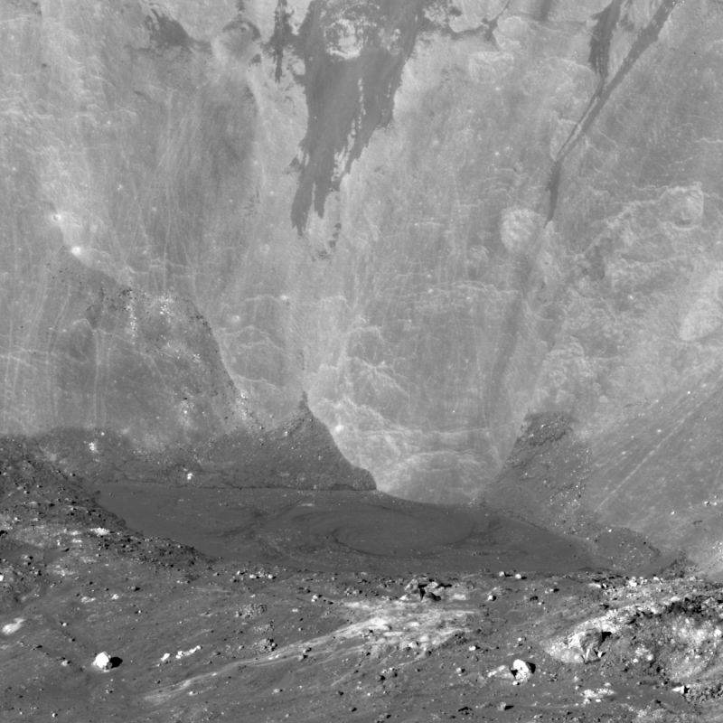 Steep cliff of gray rock and darker regolith at the bottom.