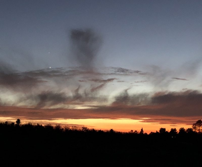 Two shining planets in a twilight sky that also contains virga, or rain that doesn't reach the ground.