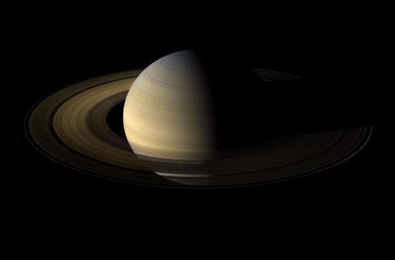 Saturn and rings illuminated from one side.