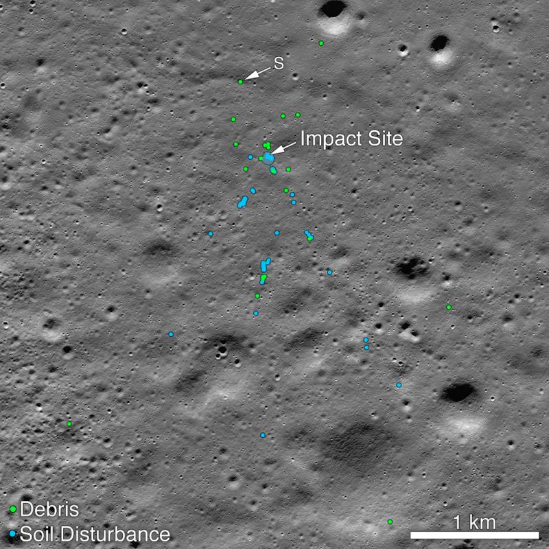 A portion of the moon with blue and green dots indicating spacecraft debris and soil disturbance.