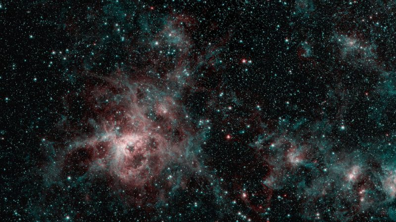 Wispy nebula with starry background.