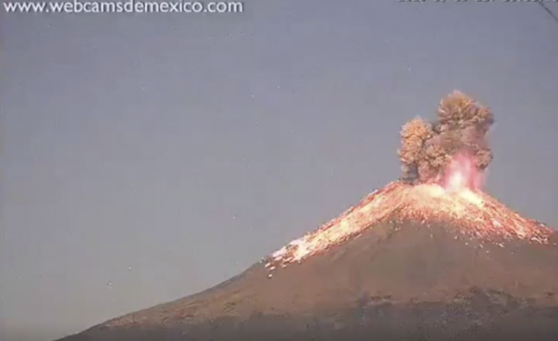 Video still of volcanic eruption: fire, smoke, lava.