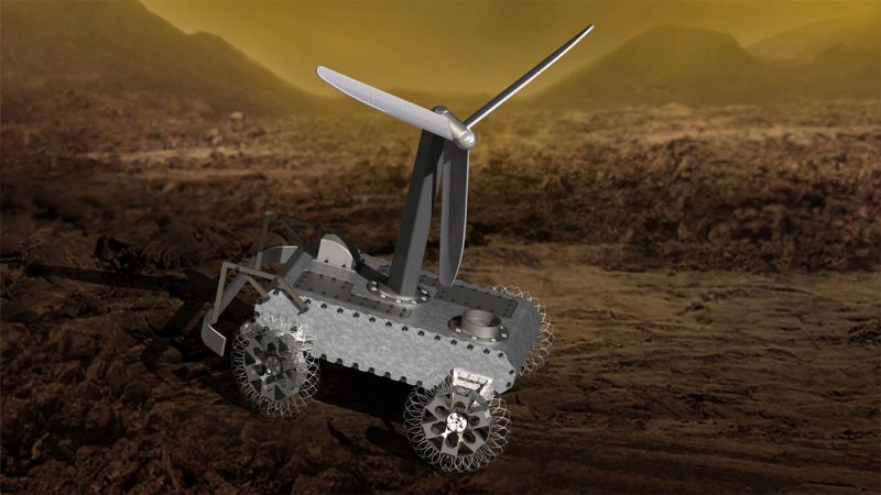Rover with propeller on top, on rocky ground.