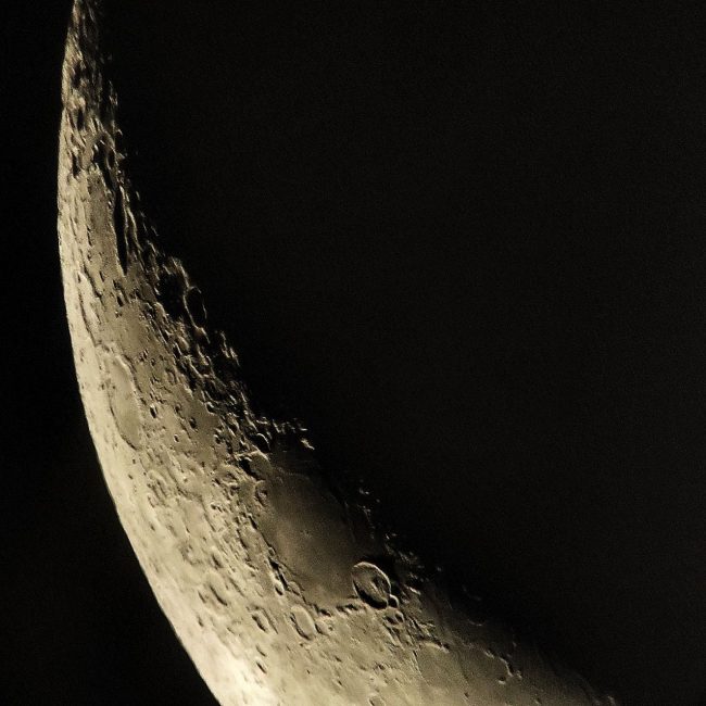 Close-up of a portion of the waning crescent moon.