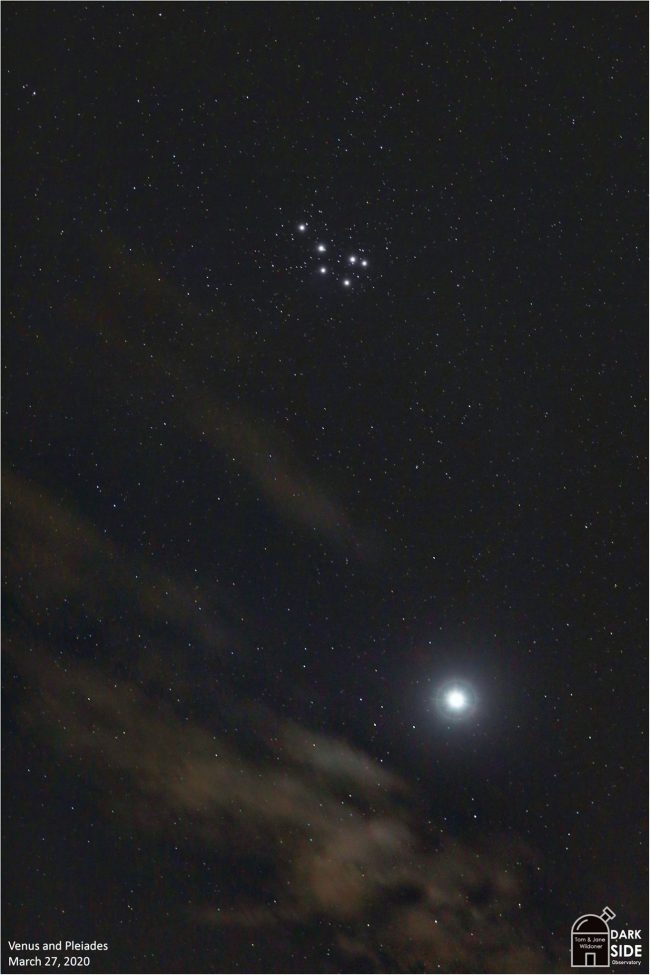 Venus and Pleiades in star field with wispy clouds.