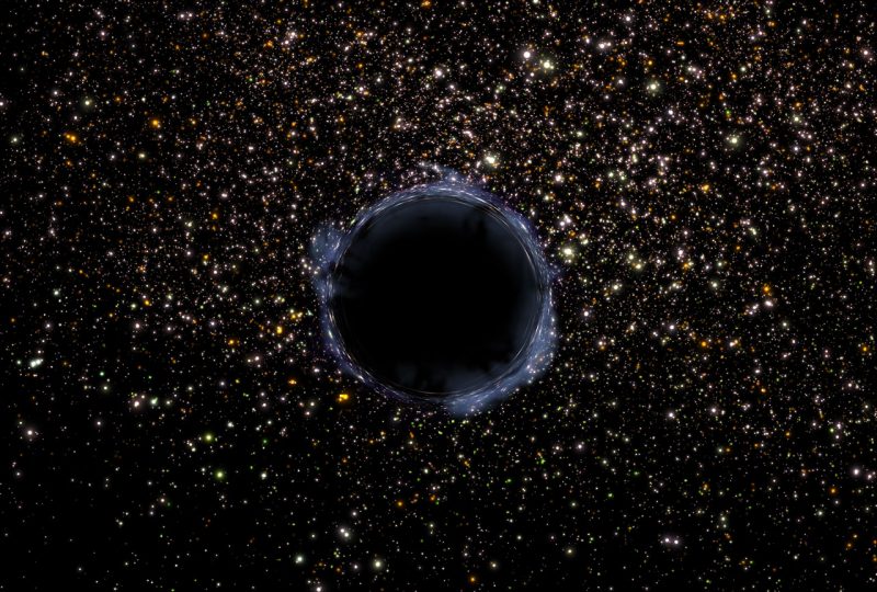 A black object on a field of stars.
