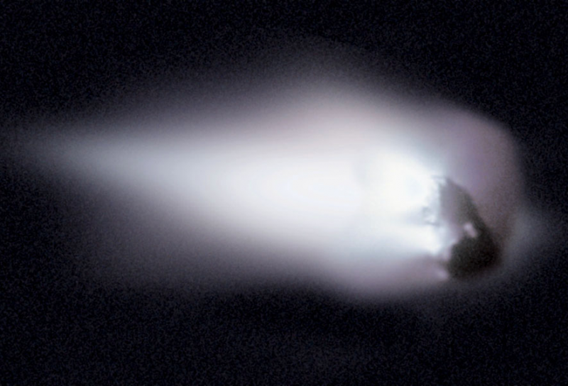 Comet Halley: A rocky body hurtling through space, surrounded by a cloud of haze.