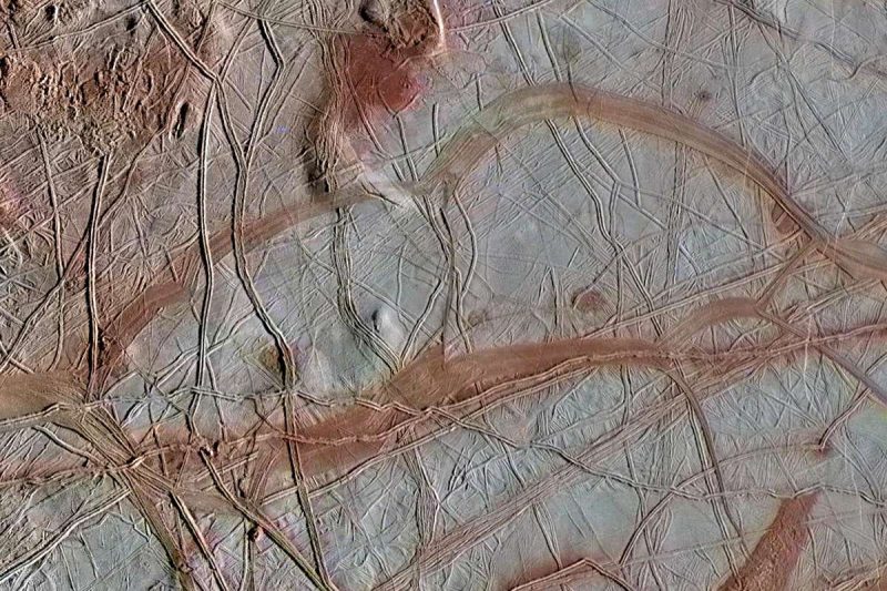 Light-colored terrain with many brown cracks and streaks.