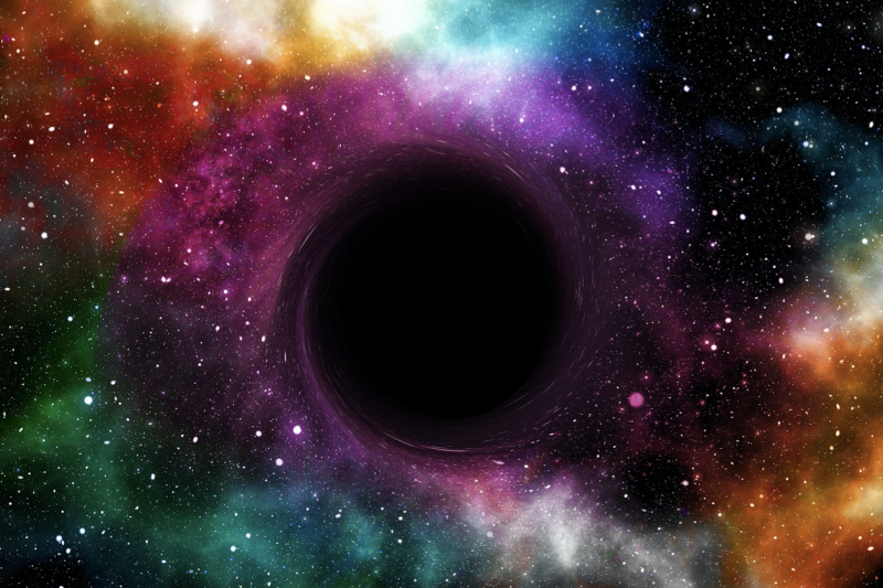 A space scene with a big black empty-looking ball in the middle.