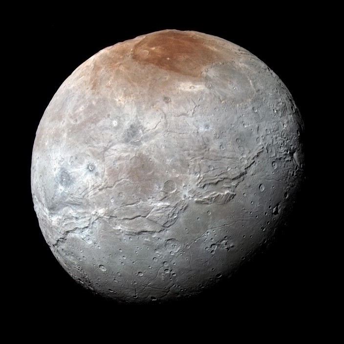 Mottled gray globe with russet patch on top and long belt of mountains and cracks nearly around equator.