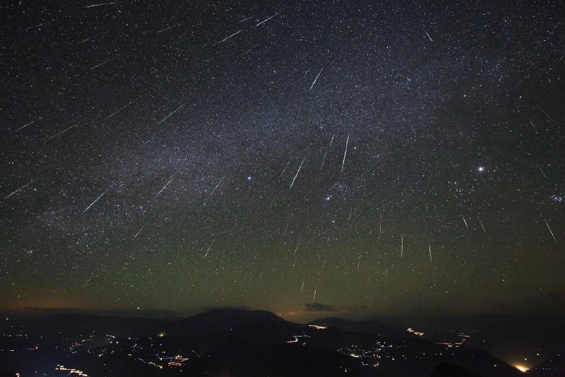 Starry sky from composite images showing meteors over several hours from meteor shower radiant point.