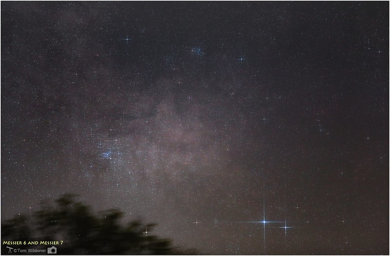 Night sky with two close-together, brilliant stars and two patches of multiple stars nearby.