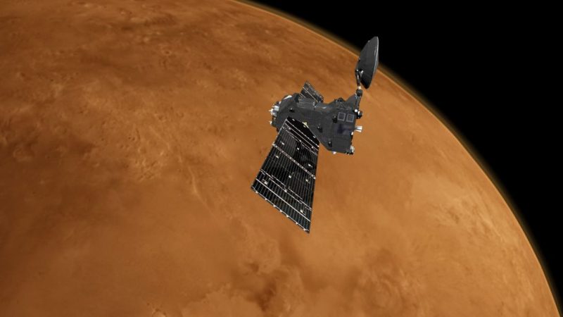 Boxy satellite with wide panel and dish antenna orbiting reddish Mars.