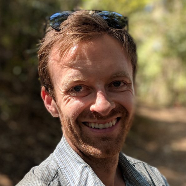 Smiling man with sunglasses on his head.