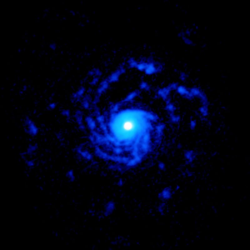 Large blue spiral formation with white center on black background.
