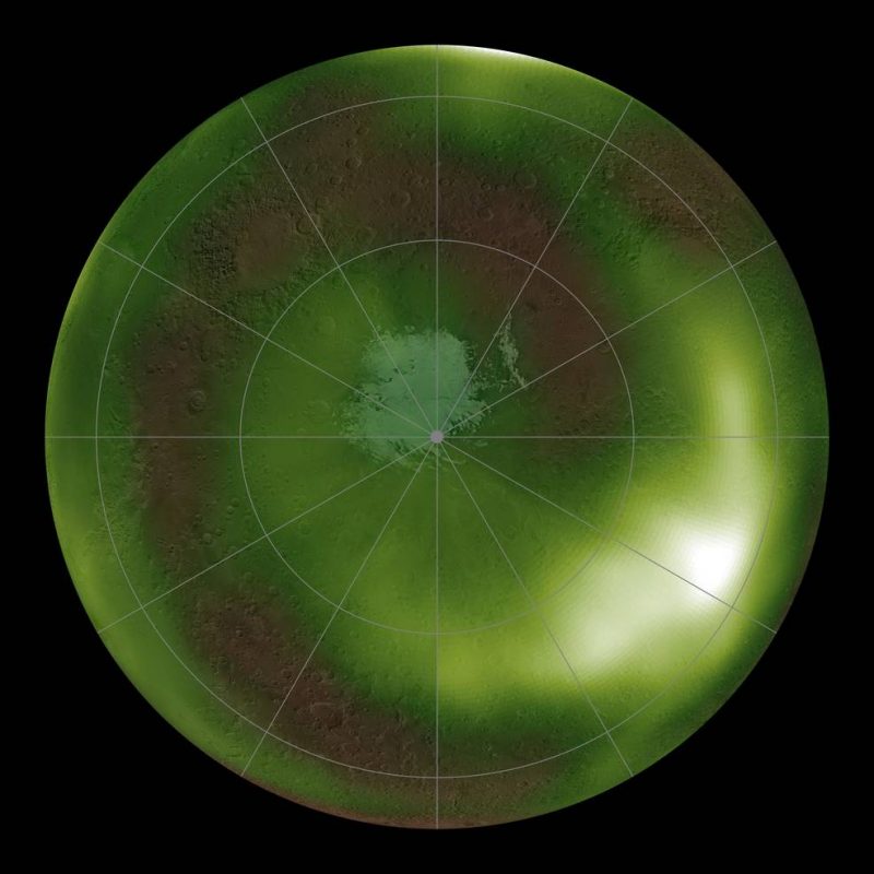 Polar view of Mars in green with latitude and longitude lines, and a large blurry white area on lower right.