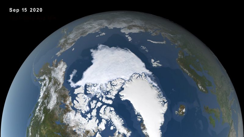 Orbital view of Arctic with large areas covered in white, surrounded by blue water.
