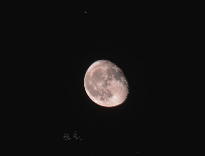 Telescopic image of the waning gibbous moon and Mars.