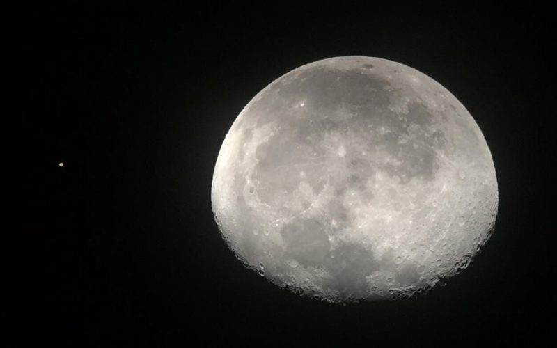 Telescopic image of the waning gibbous moon and Mars.