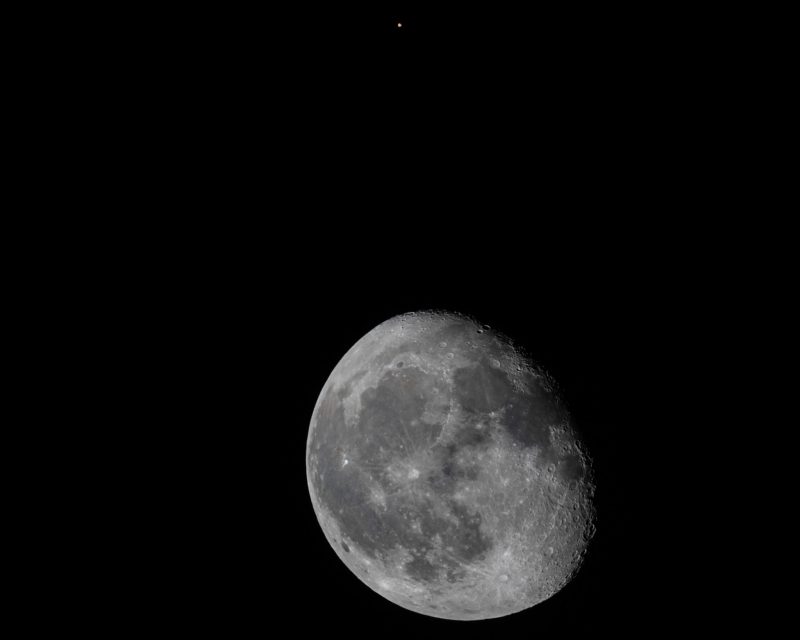 Telescopic image of the waning gibbous moon and Mars.