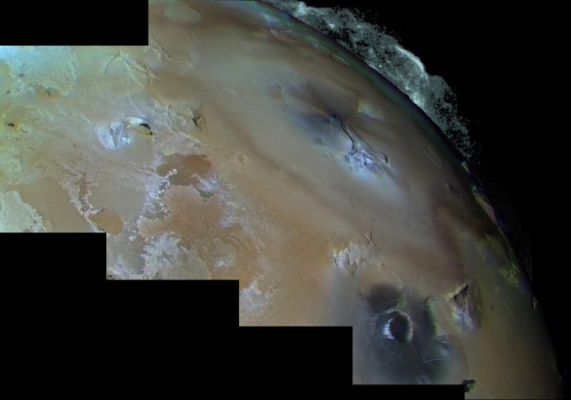 Mottled colored terrain with large plume on the edge, on black background.