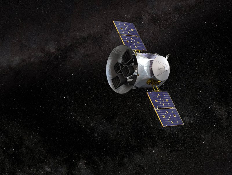Bell-shaped satellite with solar panel wings, in space with stars in background.