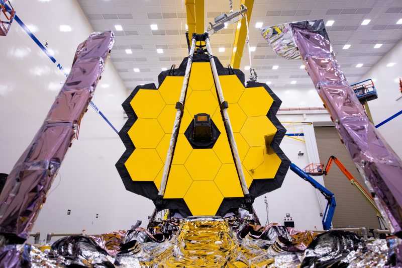 Giant golden hexagon made of smaller hexagons, with foil-covered arms in foreground.