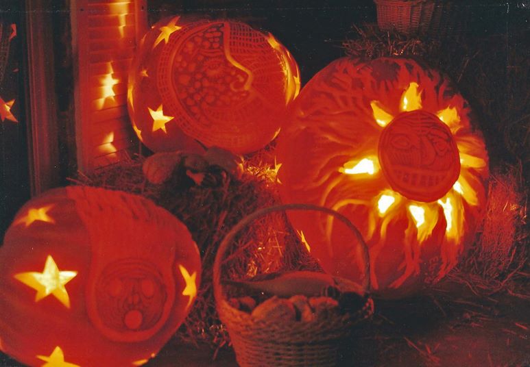 Glowing pumpkins with stars and a comet carved into them.