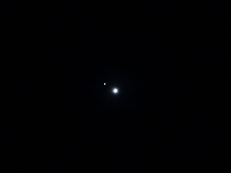 Bright planet Venus and fainter star Regulus., in a black sky
