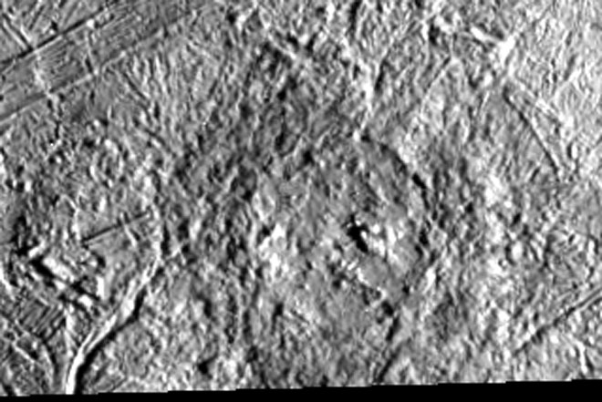 Circular feature on fractured gray terrain.