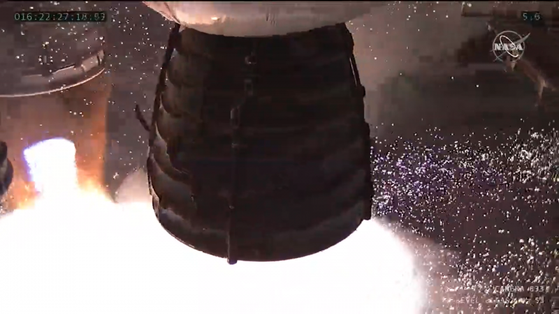 A close-up of a single engine firing with white gases or steam pouring from it.