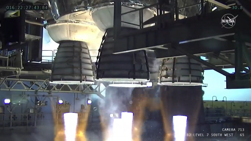 Ground-level view of 4 large rocket engines firing downward.