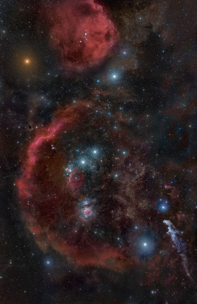 Stars of Orian surrounded with wispy red clouds.