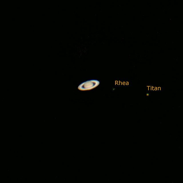 Ringed planet, plus 2 starlike dots (the moons).
