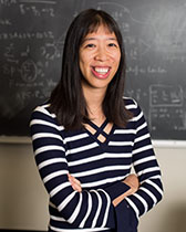 Young woman with long black hair and striped shirt.